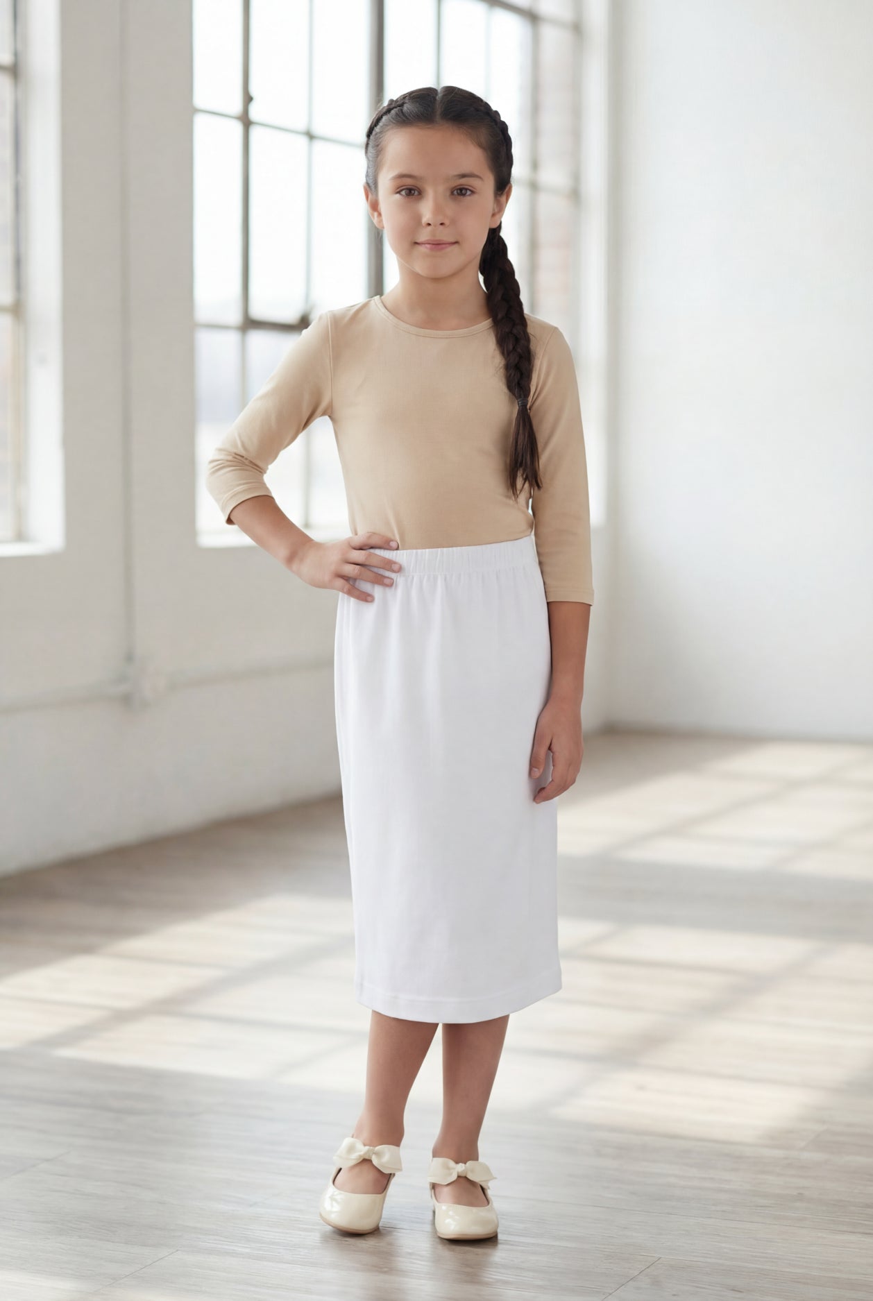 Model wearing Nuggles®  Girls Classic Skirt in White