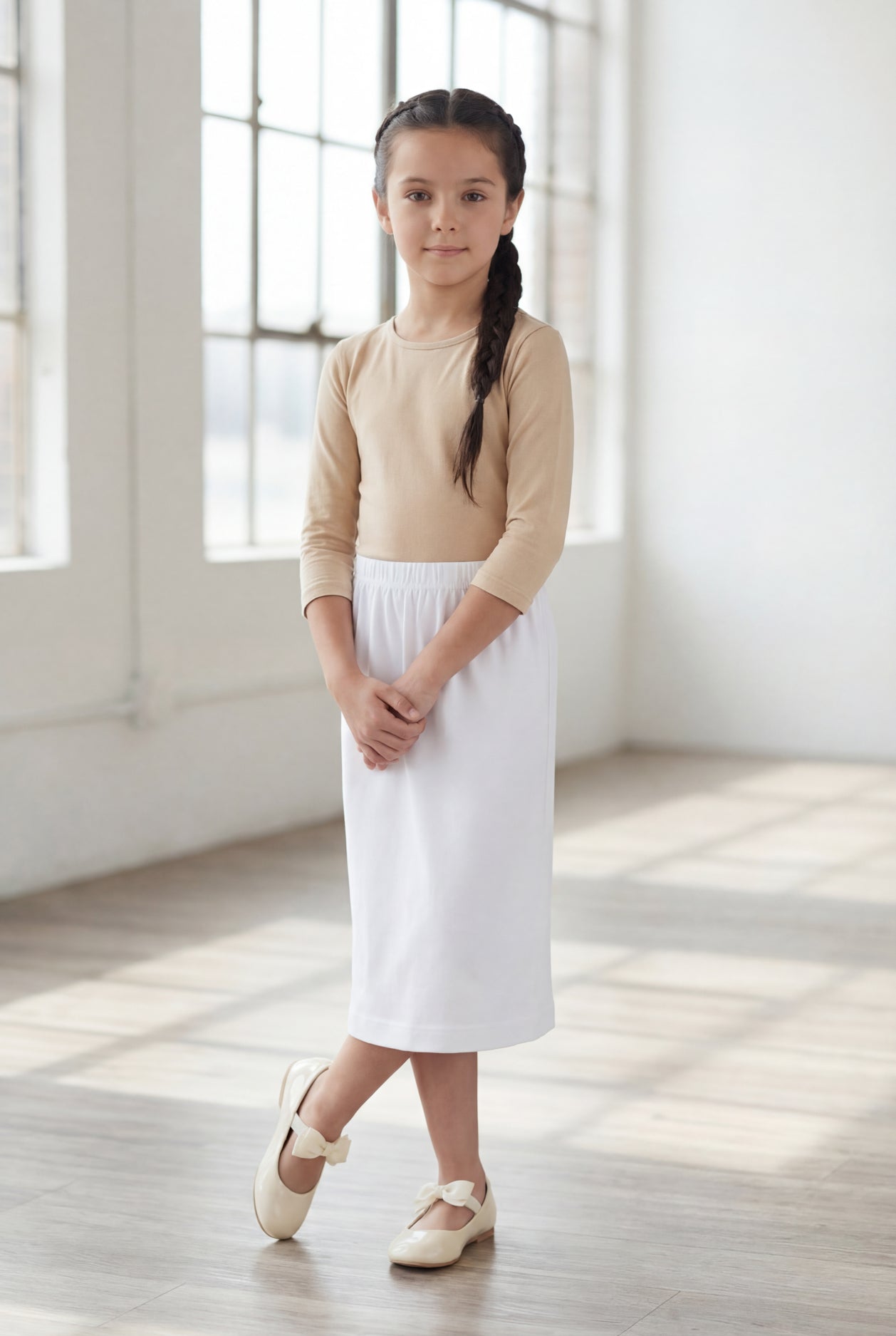 Model wearing Nuggles®  Girls Classic Skirt in White