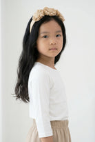 Model wearing the Girls' Nuggles® Essential 3/4 Tee in White