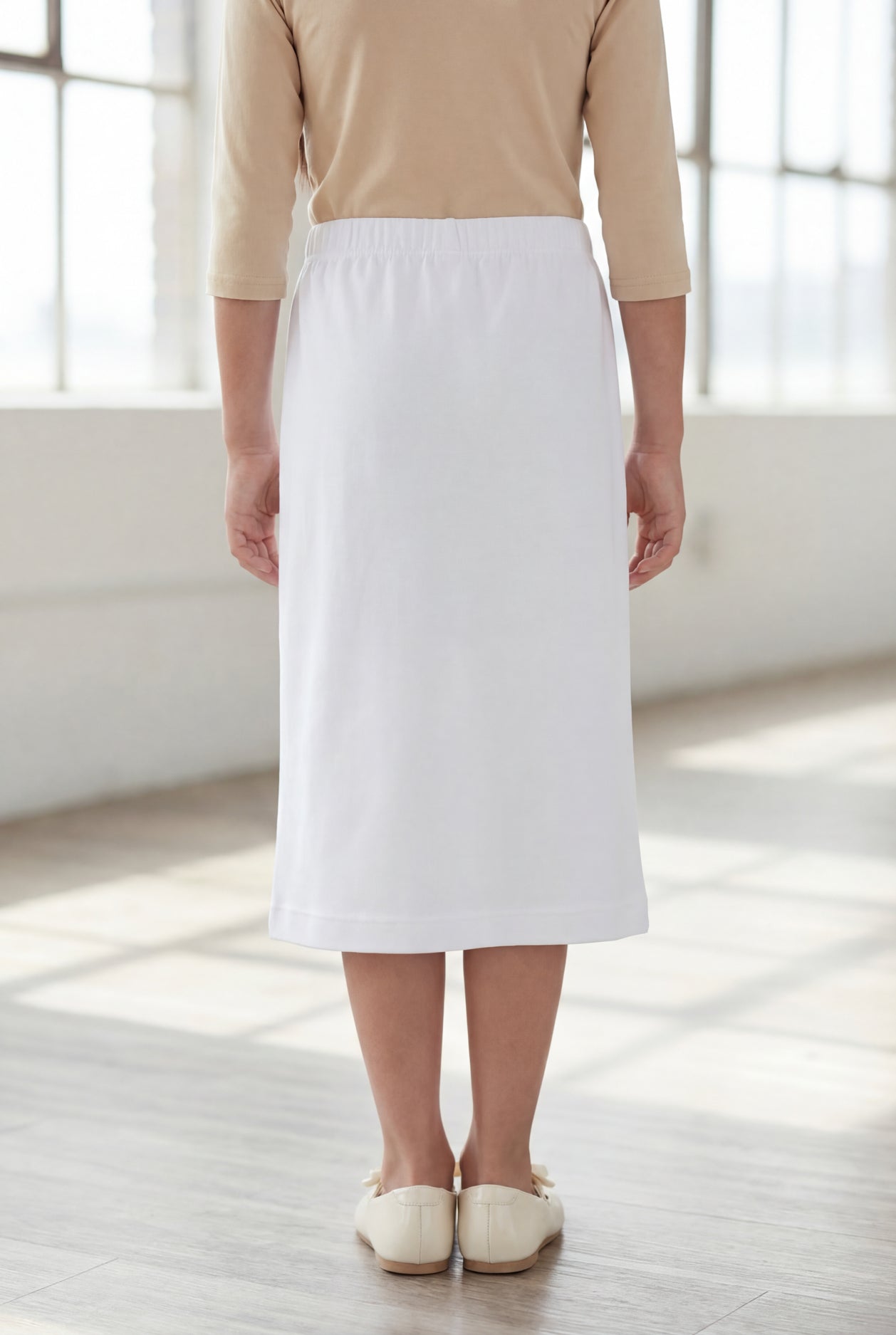 Model wearing Nuggles®  Girls Classic Skirt in White