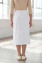 Model wearing Nuggles®  Girls Classic Skirt in White
