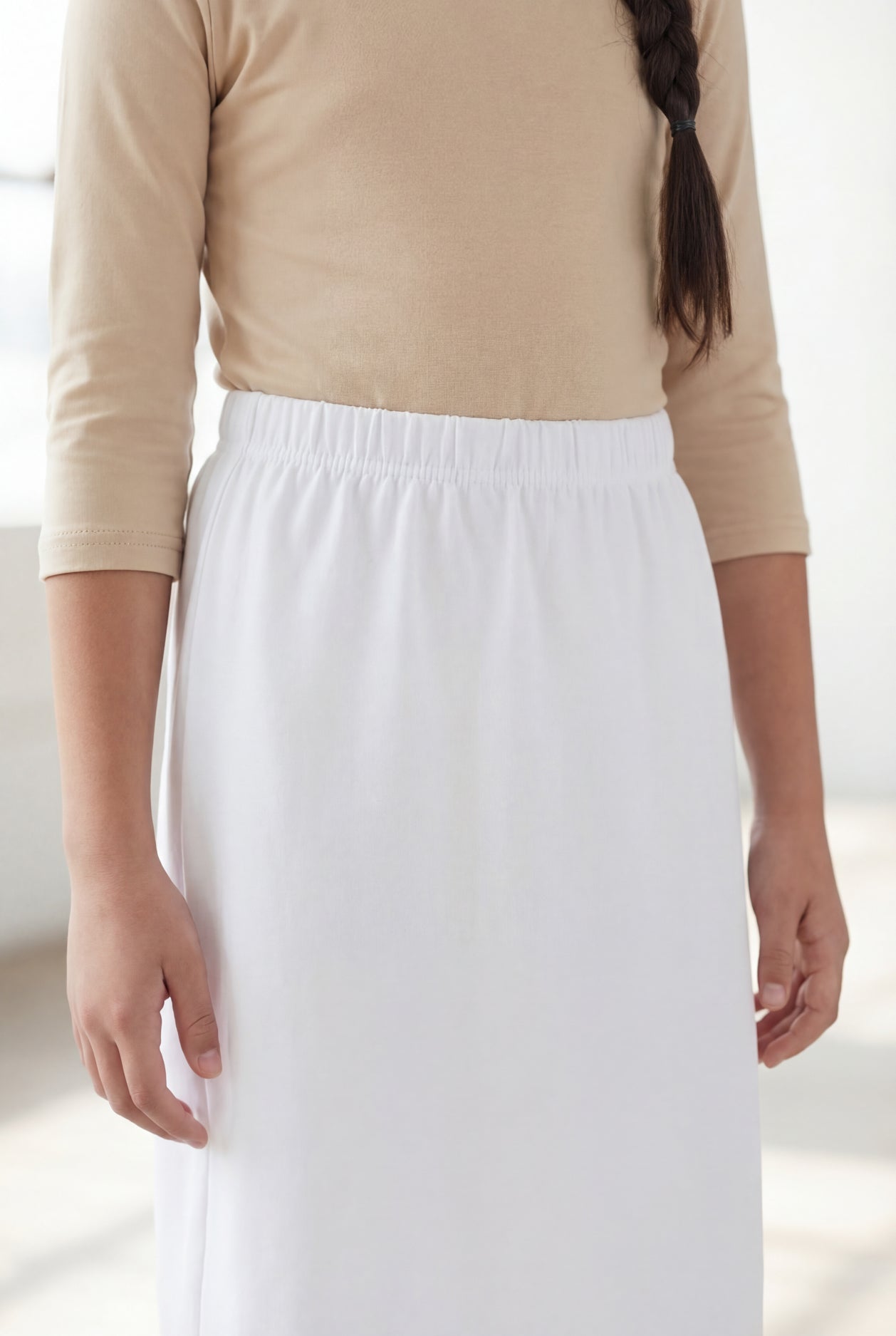 Model wearing Nuggles®  Girls Classic Skirt in White