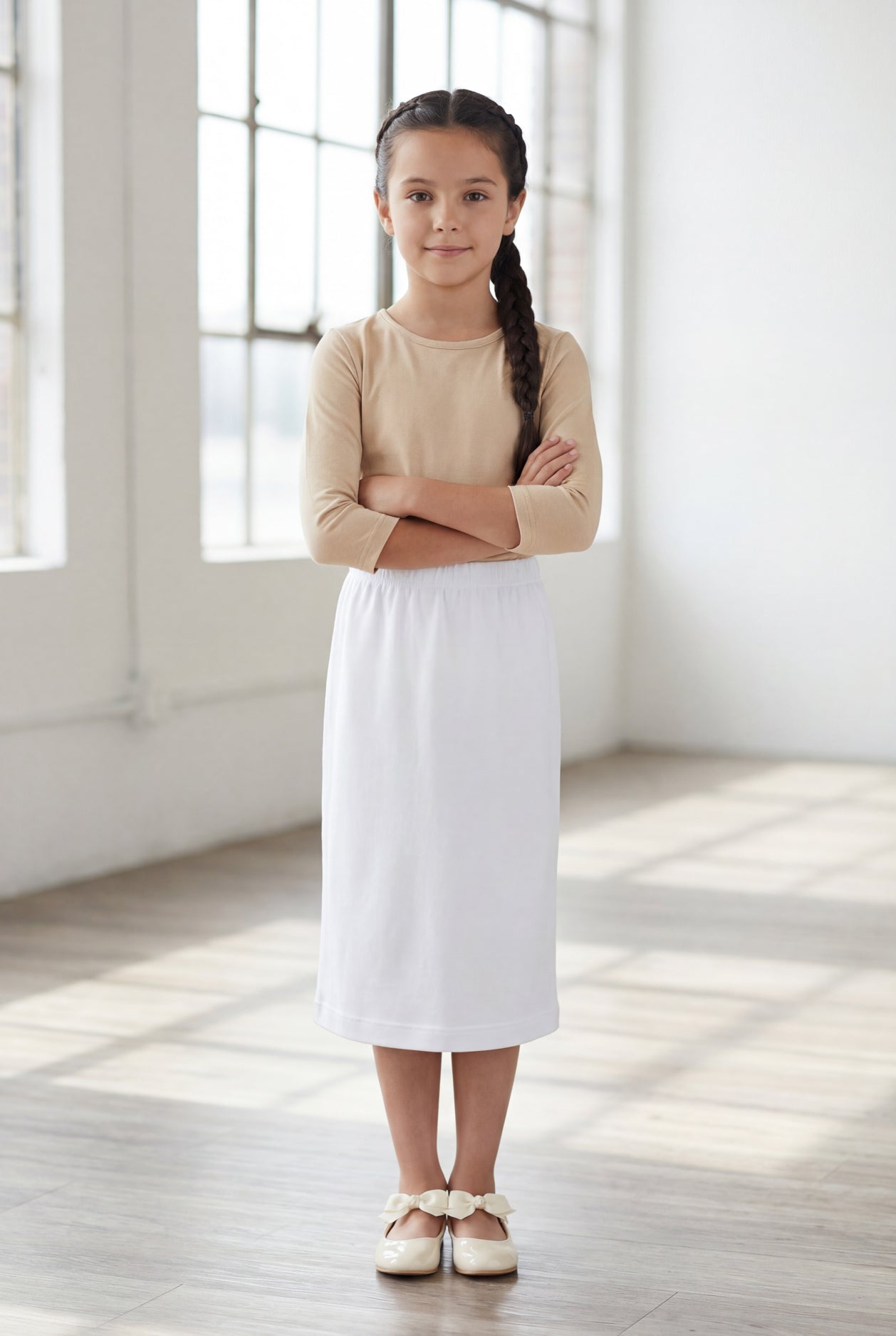 Model wearing Nuggles®  Girls Classic Skirt in White