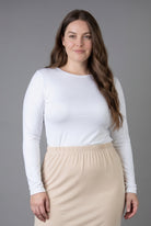 Model wearing Nuggles® Long Sleeve Essential Tee in White
