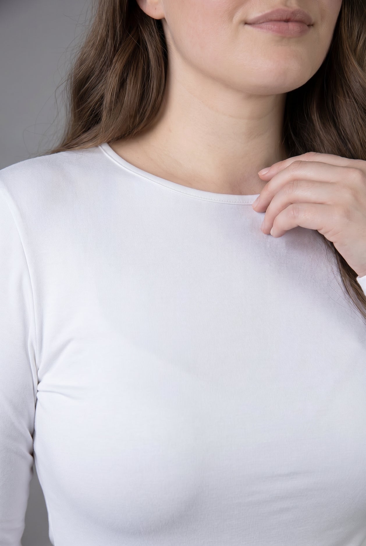 Model wearing Nuggles® Long Sleeve Essential Tee in White