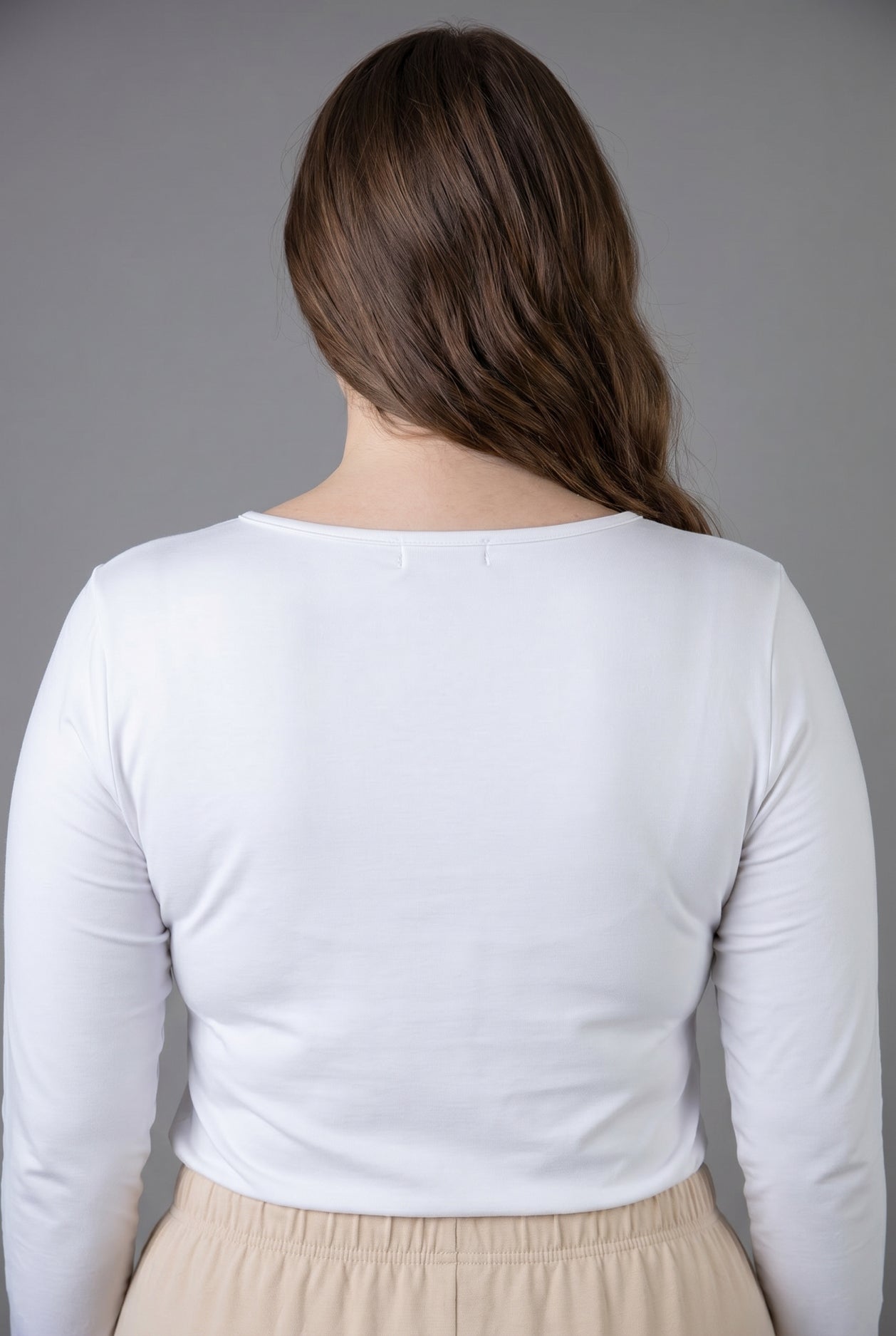 Model wearing Nuggles® Long Sleeve Essential Tee in White