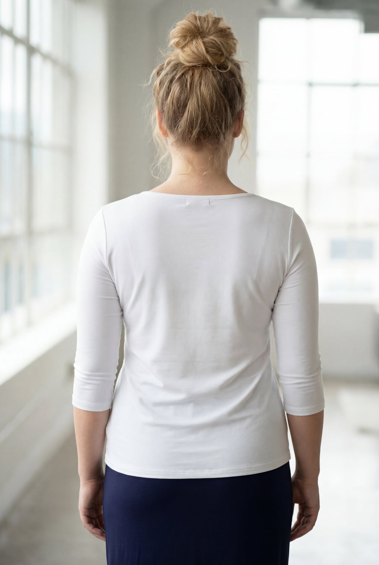 Model wearing the Nuggles® Essential 3/4 Tee in White