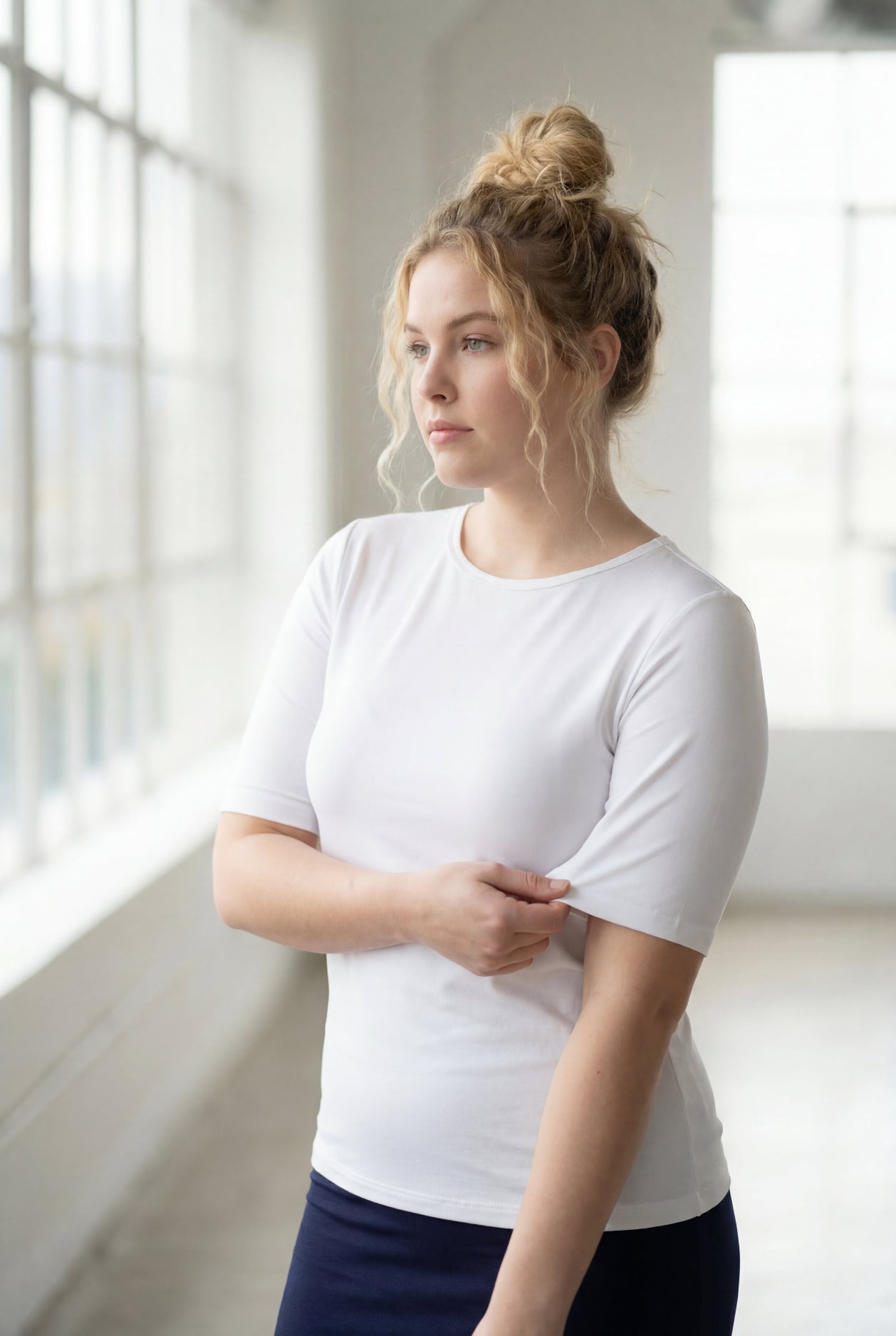 Model wearing the Nuggles® Essential Half Sleeve Tee in White