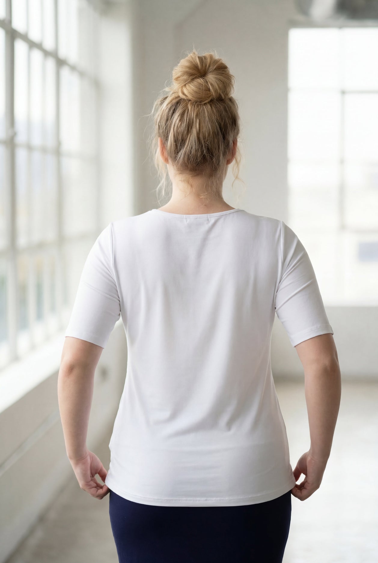 Model wearing the Nuggles® Essential Half Sleeve Tee in White