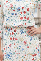 Nuggles Wildflower Meadow midi dress, maternity-friendly modest floral dress on soft ivory