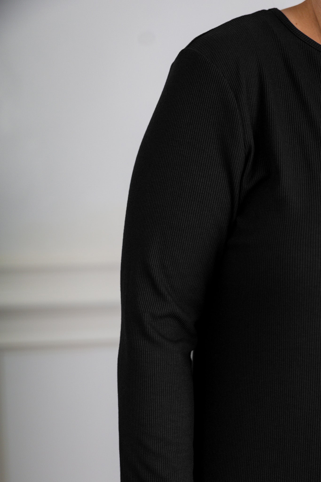 model wearing a ribbed midi dress from Nuggles® with modest 3/4 sleeves and high neckline.