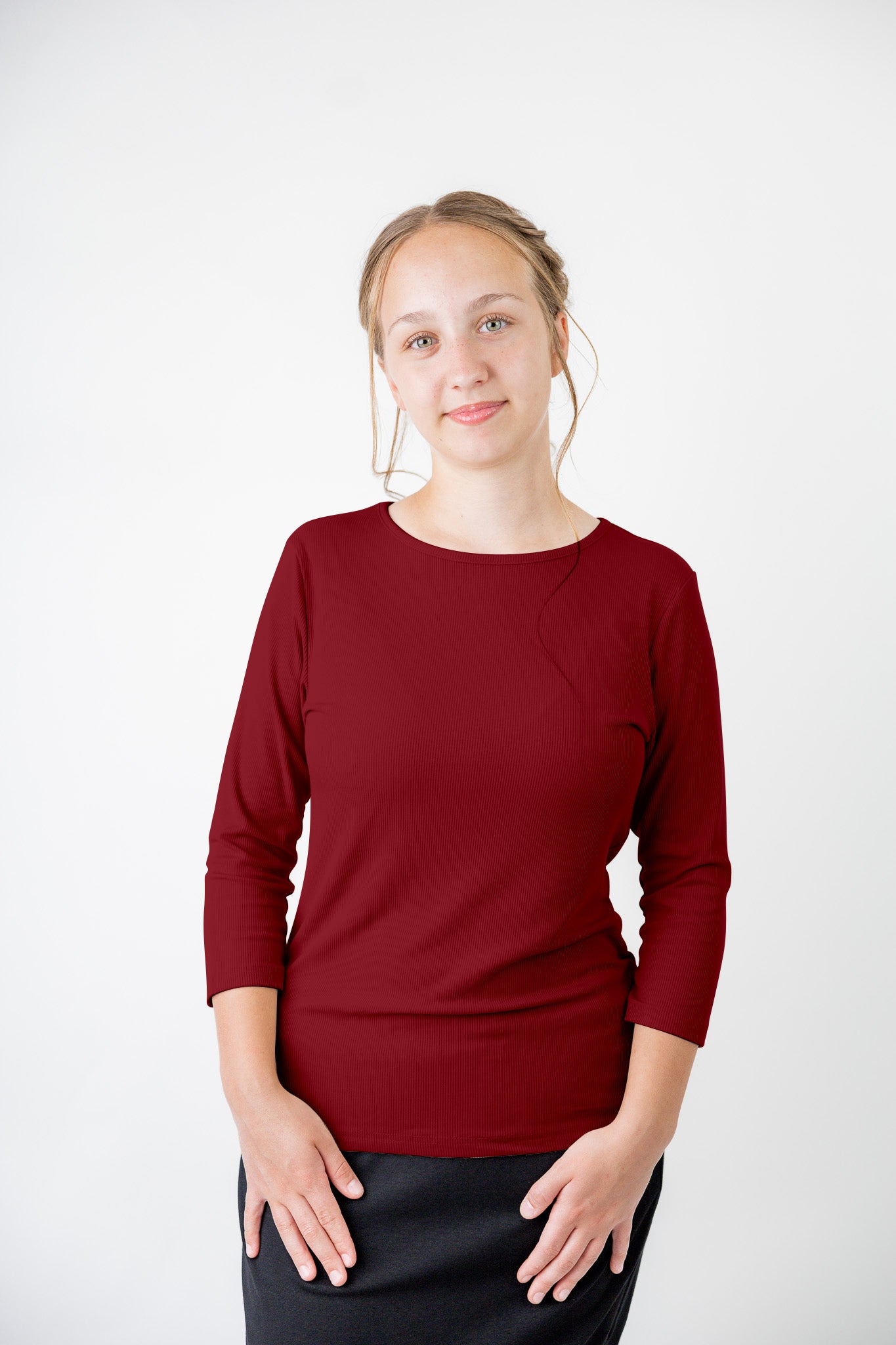 Model wearing the  Nuggles®  Essential 3/4 Tee in ribbed fabric, a modest, fitted top with 3/4 sleeves and a rounded neckline. Shown in a neutral tone, ideal for layering.