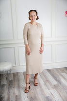 model wearing a ribbed midi dress from Nuggles® with modest 3/4 sleeves and high neckline.
