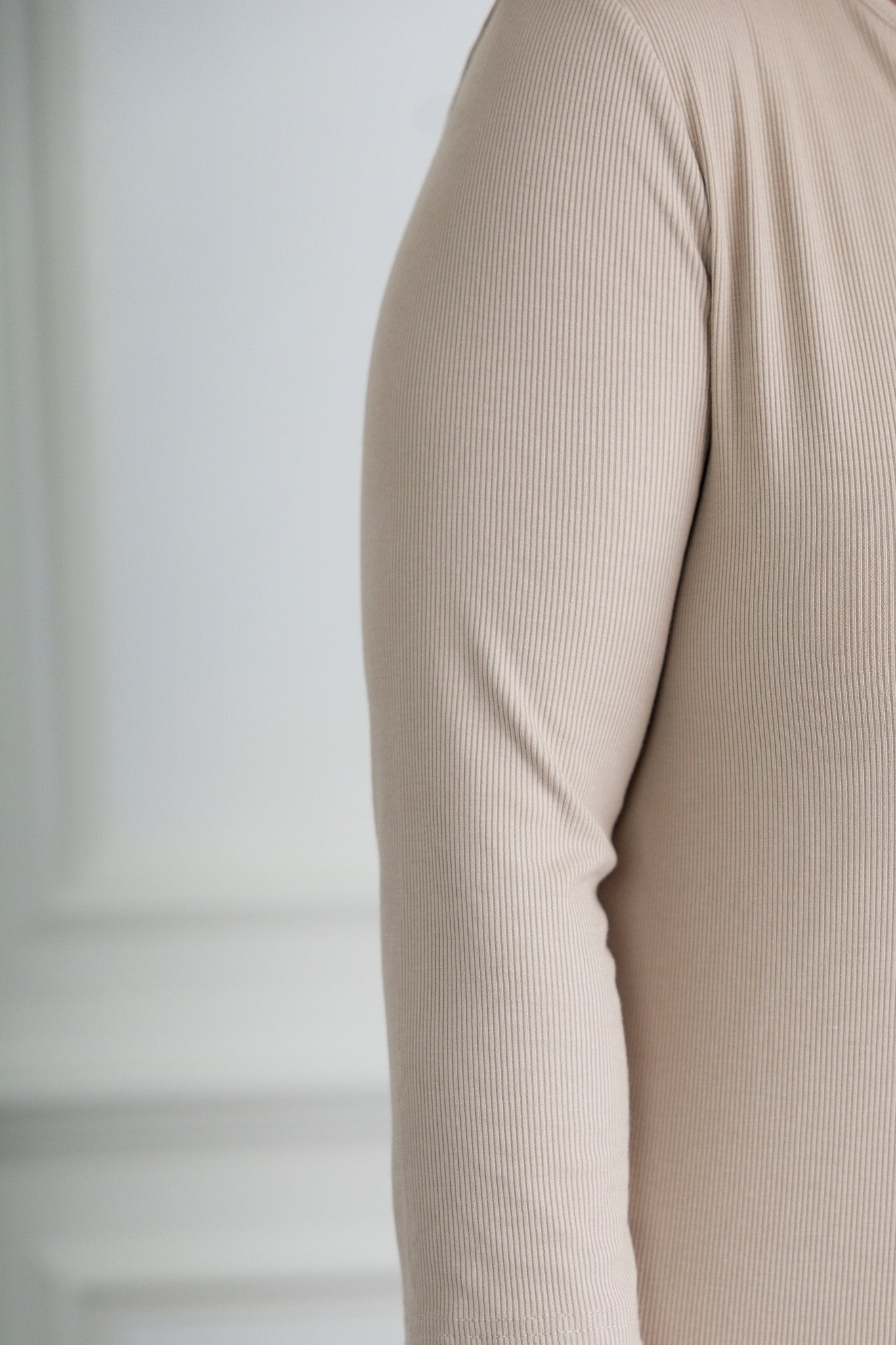 model wearing a ribbed midi dress from Nuggles® with modest 3/4 sleeves and high neckline.