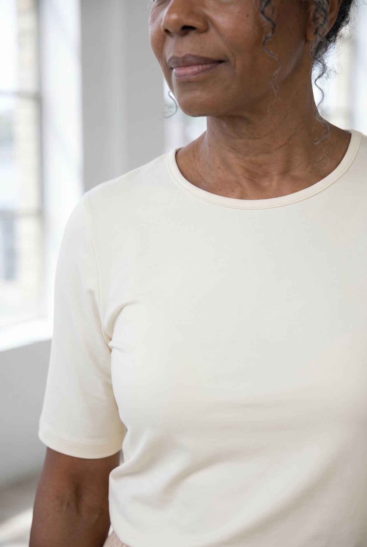 Model wearing Nuggles®  Half Sleeve Essential Tee in Cream