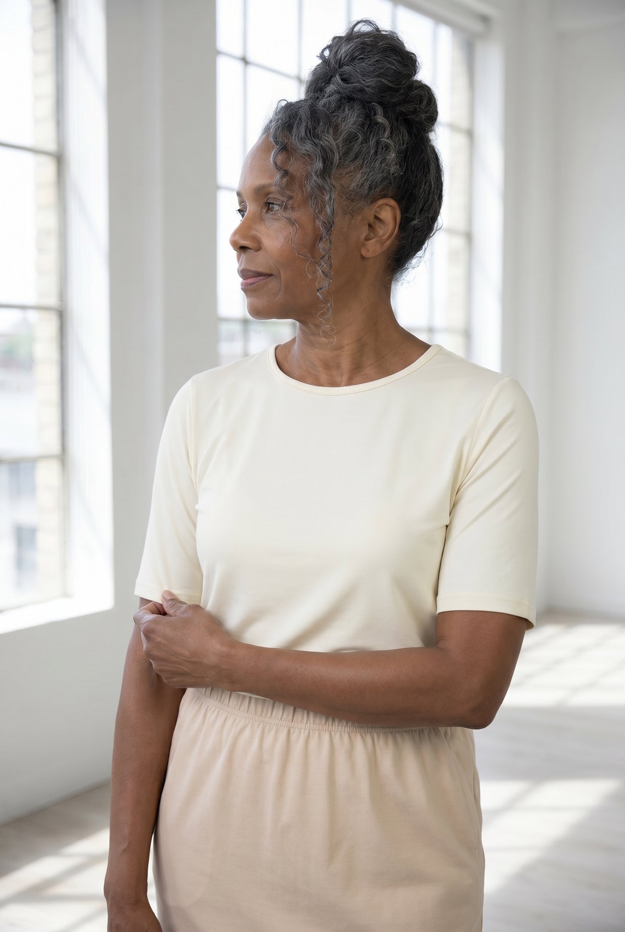 Model wearing Nuggles®  Half Sleeve Essential Tee in Cream
