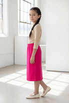 Model wearing the Nuggles® Girls' Classic Midi Skirt in Hot Pink 