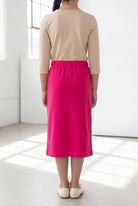 Model wearing the Nuggles® Girls' Classic Midi Skirt in Hot Pink 