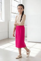 Model wearing the Nuggles® Girls' Classic Midi Skirt in Hot Pink 