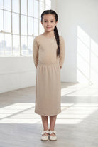Model wearing the Nuggles® Girls' Classic Midi Skirt in Khaki