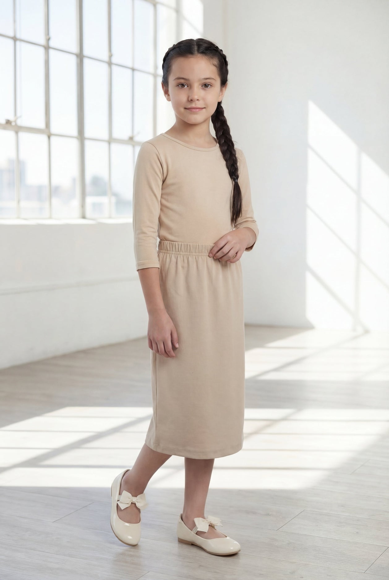 Model wearing the Nuggles® Girls' Classic Midi Skirt in Khaki