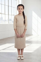 Model wearing the Nuggles® Girls' Classic Midi Skirt in Khaki