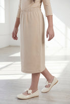Model wearing the Nuggles® Girls' Classic Midi Skirt in Khaki