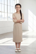 Model wearing the Nuggles® Girls' Classic Midi Skirt in Khaki
