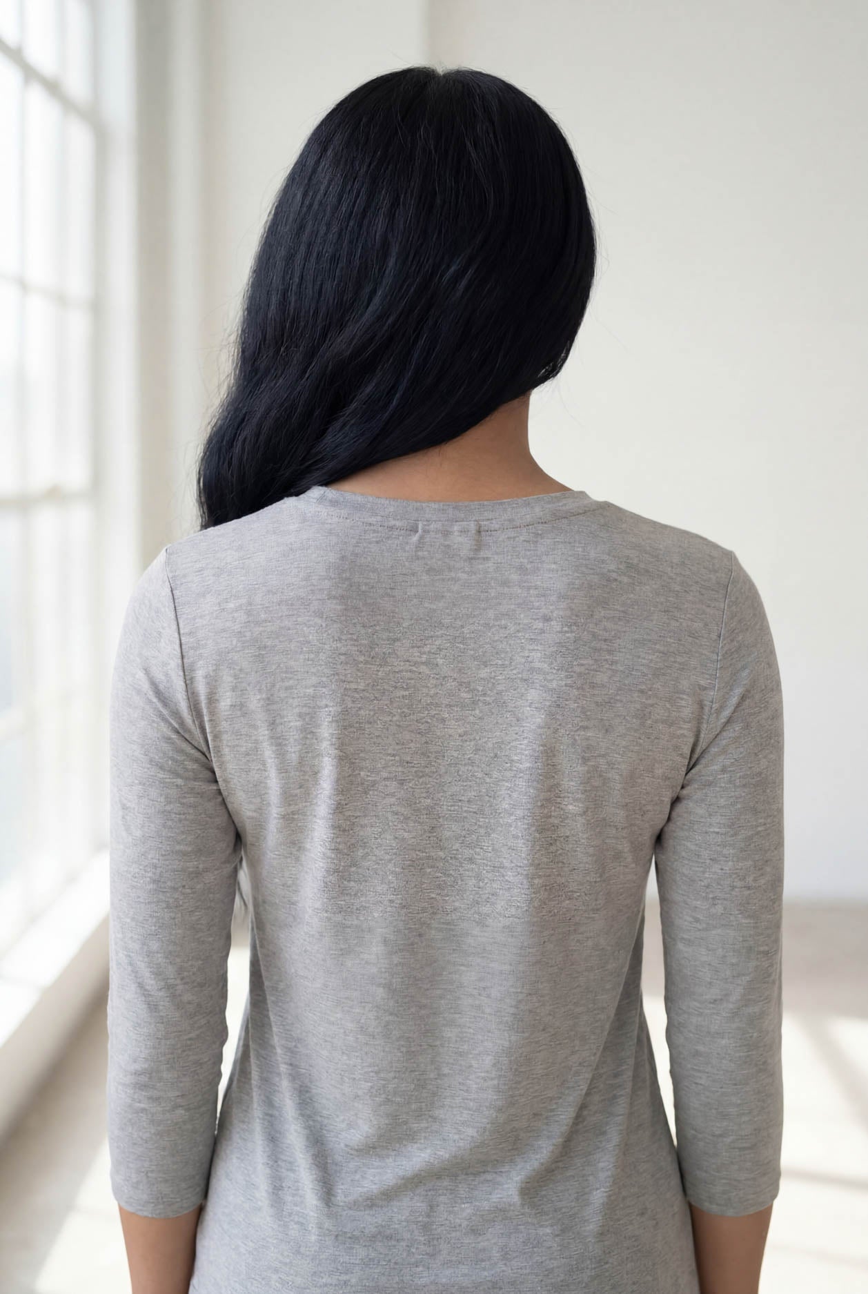 Model wearing Nuggles® 3/4 Essential Tee in Light Heather Gray