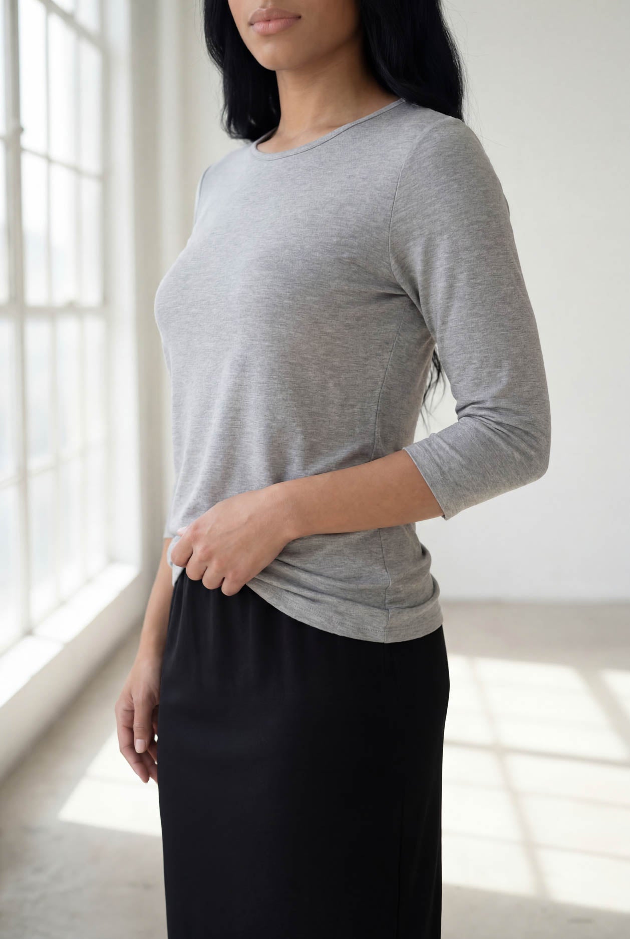 Model wearing Nuggles® 3/4 Essential Tee in Light Heather Gray