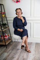 model wearing a ribbed midi dress from Nuggles® with modest 3/4 sleeves and high neckline.