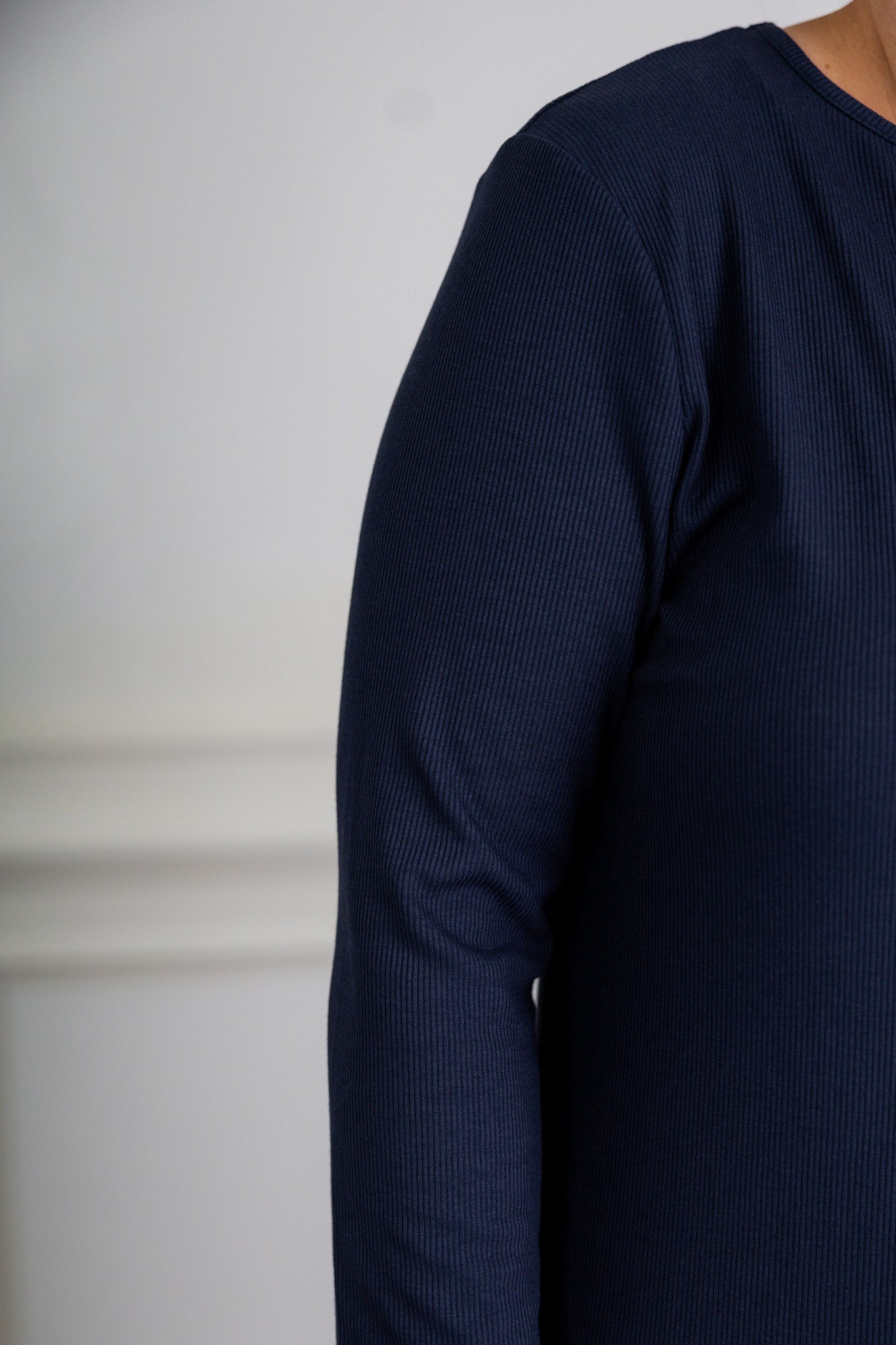 model wearing a ribbed midi dress from Nuggles® with modest 3/4 sleeves and high neckline.