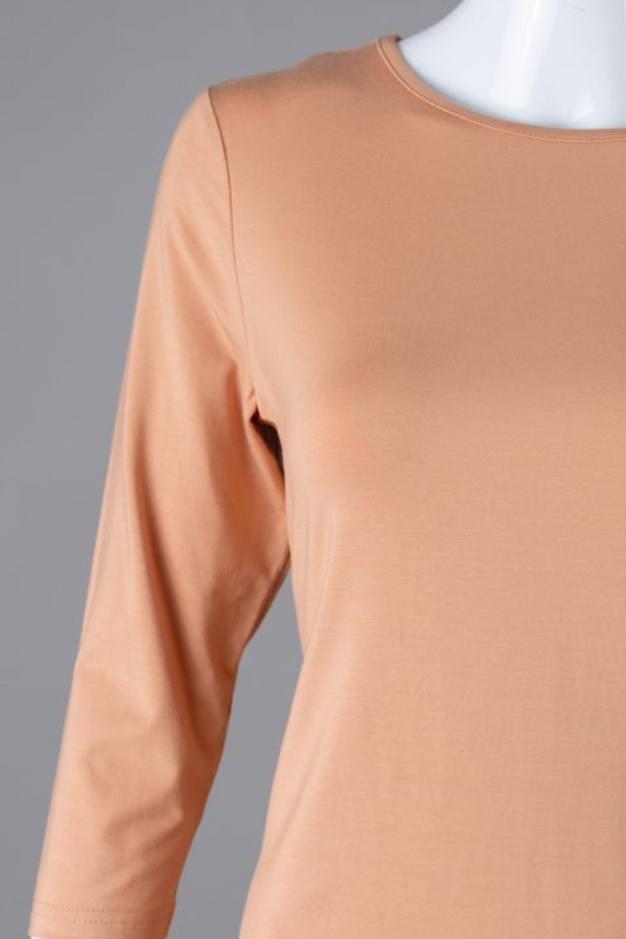 Model wearing Nuggles® 3/4 Essential Tee in Peach