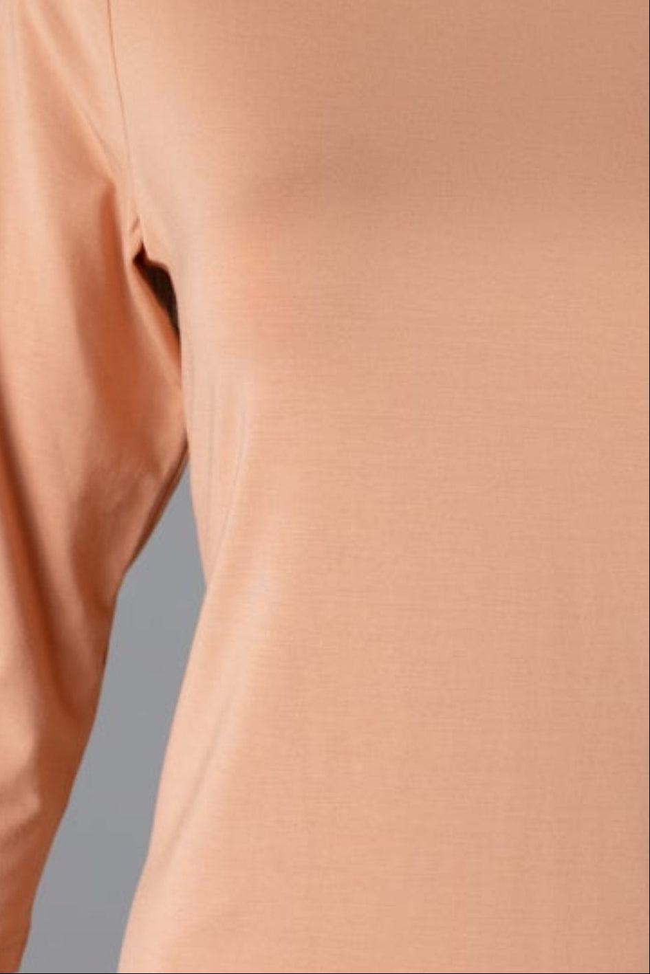 Model wearing Nuggles® 3/4 Essential Tee in Peach