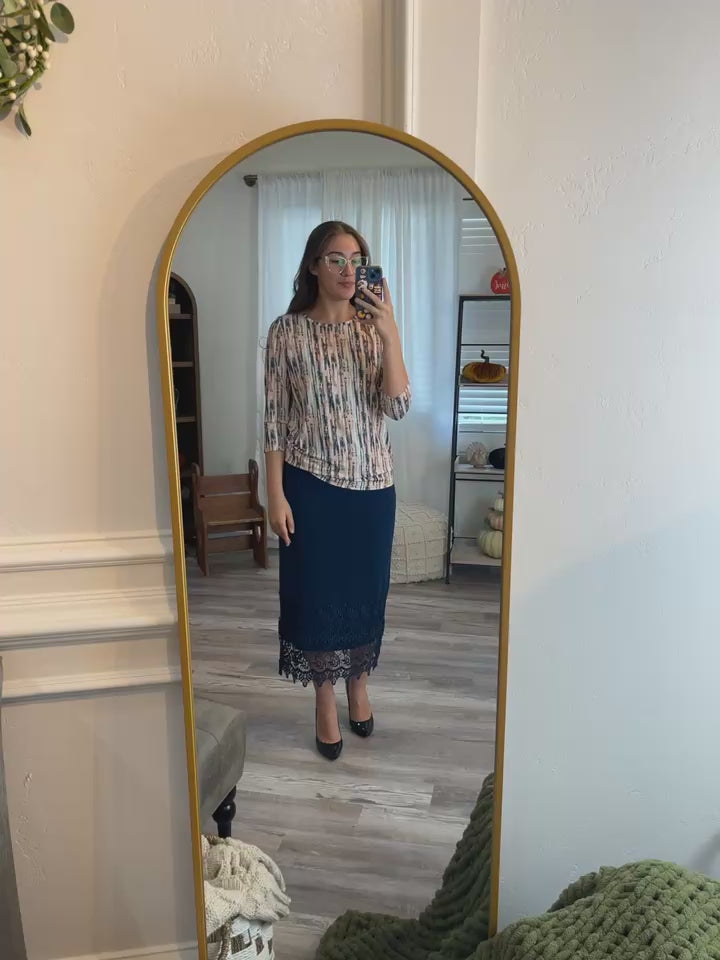 Video showcasing the Nuggles® Lace Panel Skirt, featuring soft knit fabric with elegant lace inserts, modest A-line silhouette, and flowing movement designed for everyday wear.