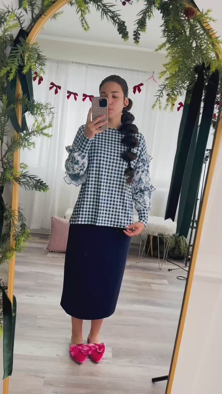 Video of model trying on the Nuggles® Rilynn Top, showing fit and sleeve details