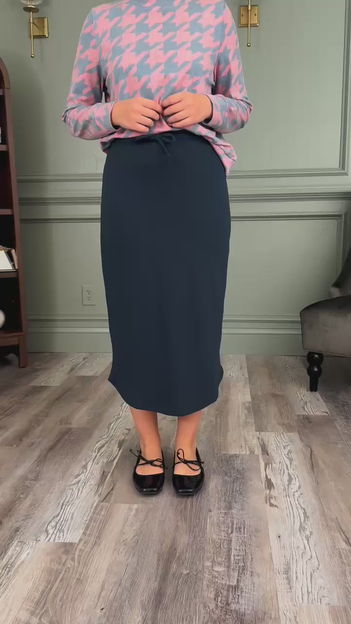 Model trying on the Nuggles® Misty Lounge Skirt, demonstrating its relaxed fit and elastic drawstring waist.