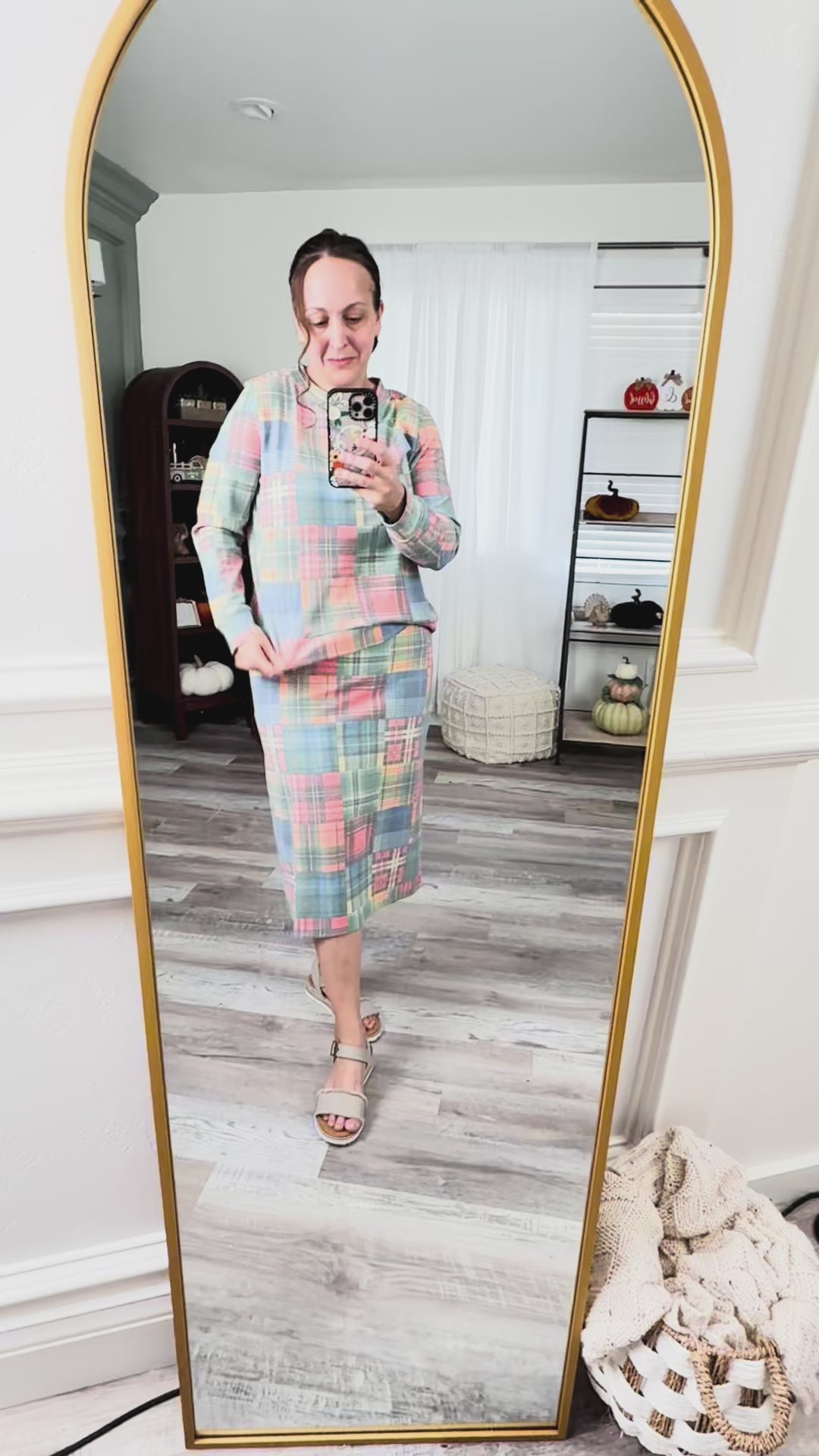 Video of model trying on Nuggles® Iris knit skirt and sweatshirt top set in assorted prints 