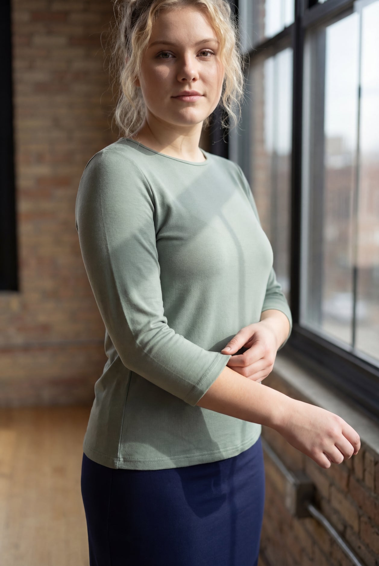 Model wearing the Nuggles® Essential 3/4 Tee in seafoam green