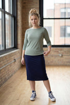 Model wearing the Nuggles® Essential 3/4 Tee in seafoam green