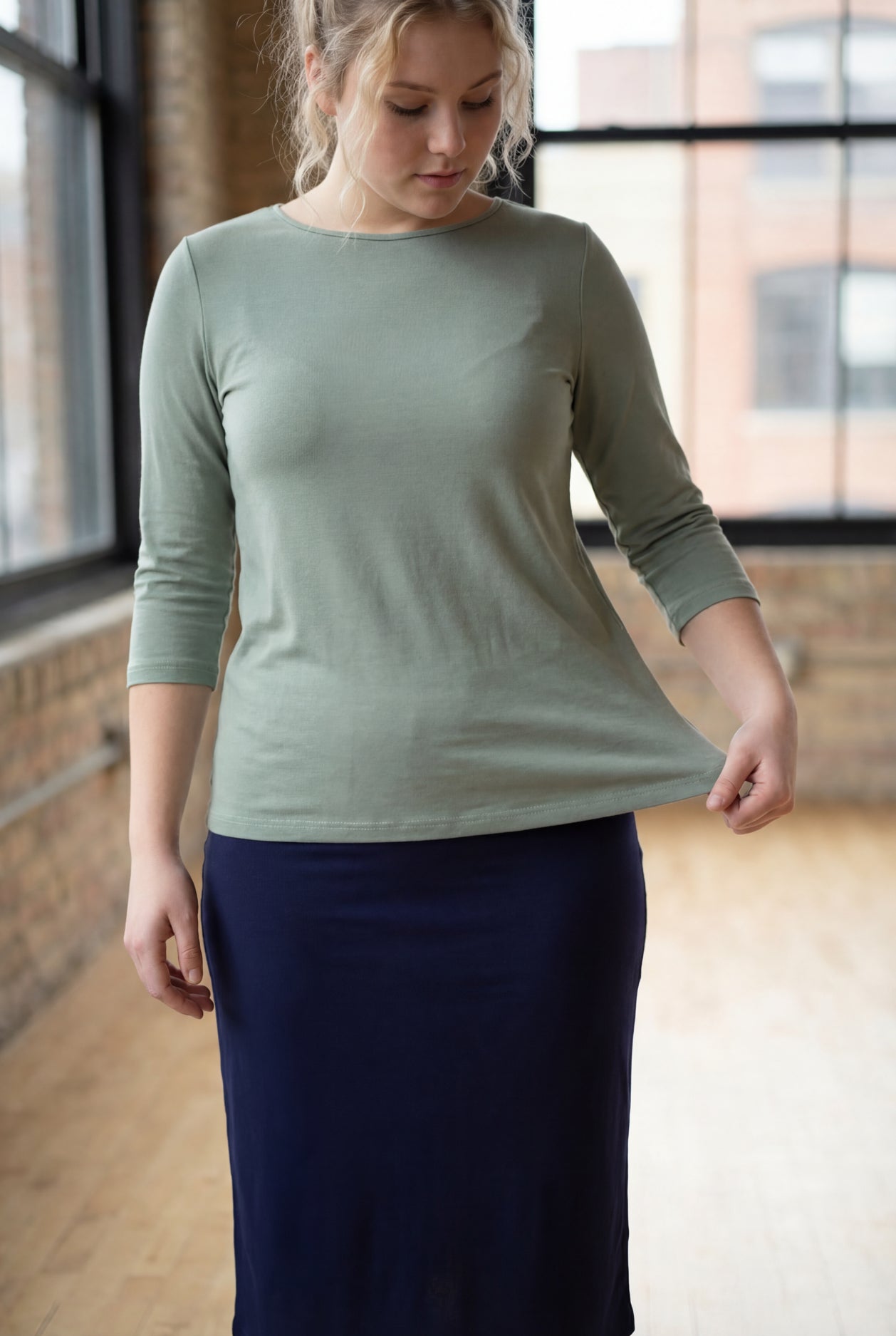 Model wearing the Nuggles® Essential 3/4 Tee in seafoam green