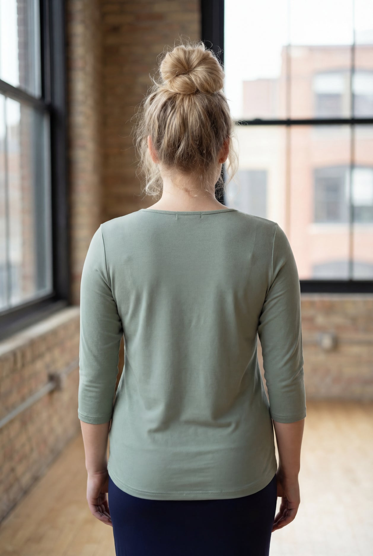 Model wearing the Nuggles® Essential 3/4 Tee in seafoam green