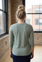 Model wearing the Nuggles® Essential 3/4 Tee in seafoam green