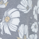 Nuggles® Daisy Moon fabric swatch — white daisies with golden centers on soft black