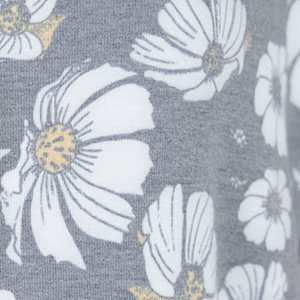 Nuggles® Daisy Moon fabric swatch — white daisies with golden centers on soft black