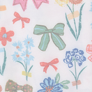 Nuggles® Garden Party fabric swatch — bows and garden florals in blue, pink and sage on cream