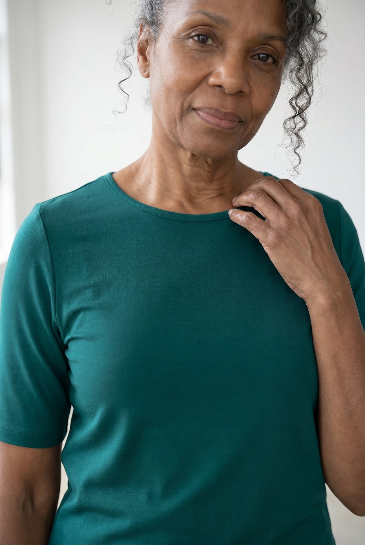 Model wearing Nuggles®  Half Sleeve Essential Tee in Teal Green