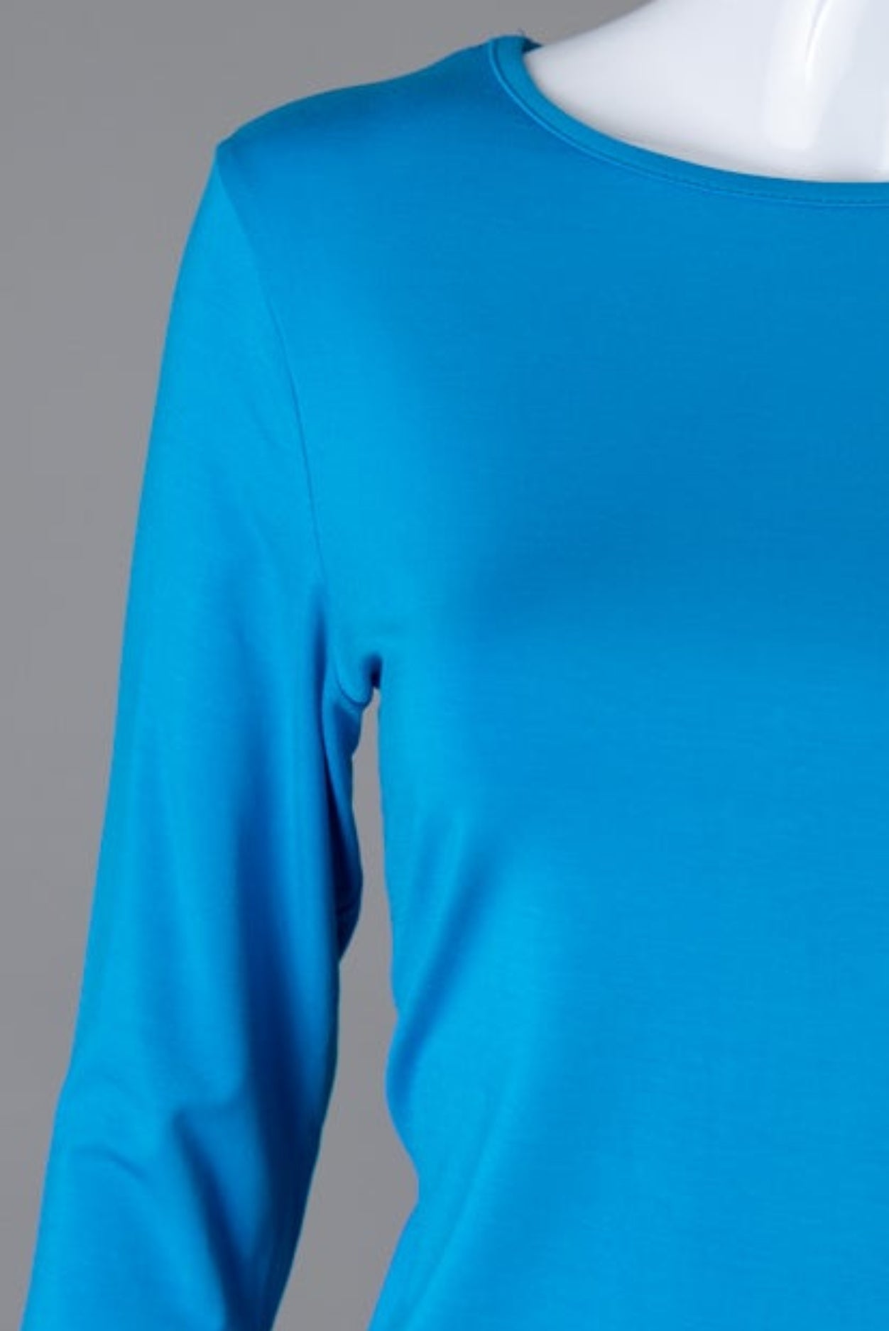 Model wearing Nuggles® 3/4 Essential Tee in Turquoise