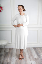 model wearing a ribbed midi dress from Nuggles® with modest 3/4 sleeves and high neckline.